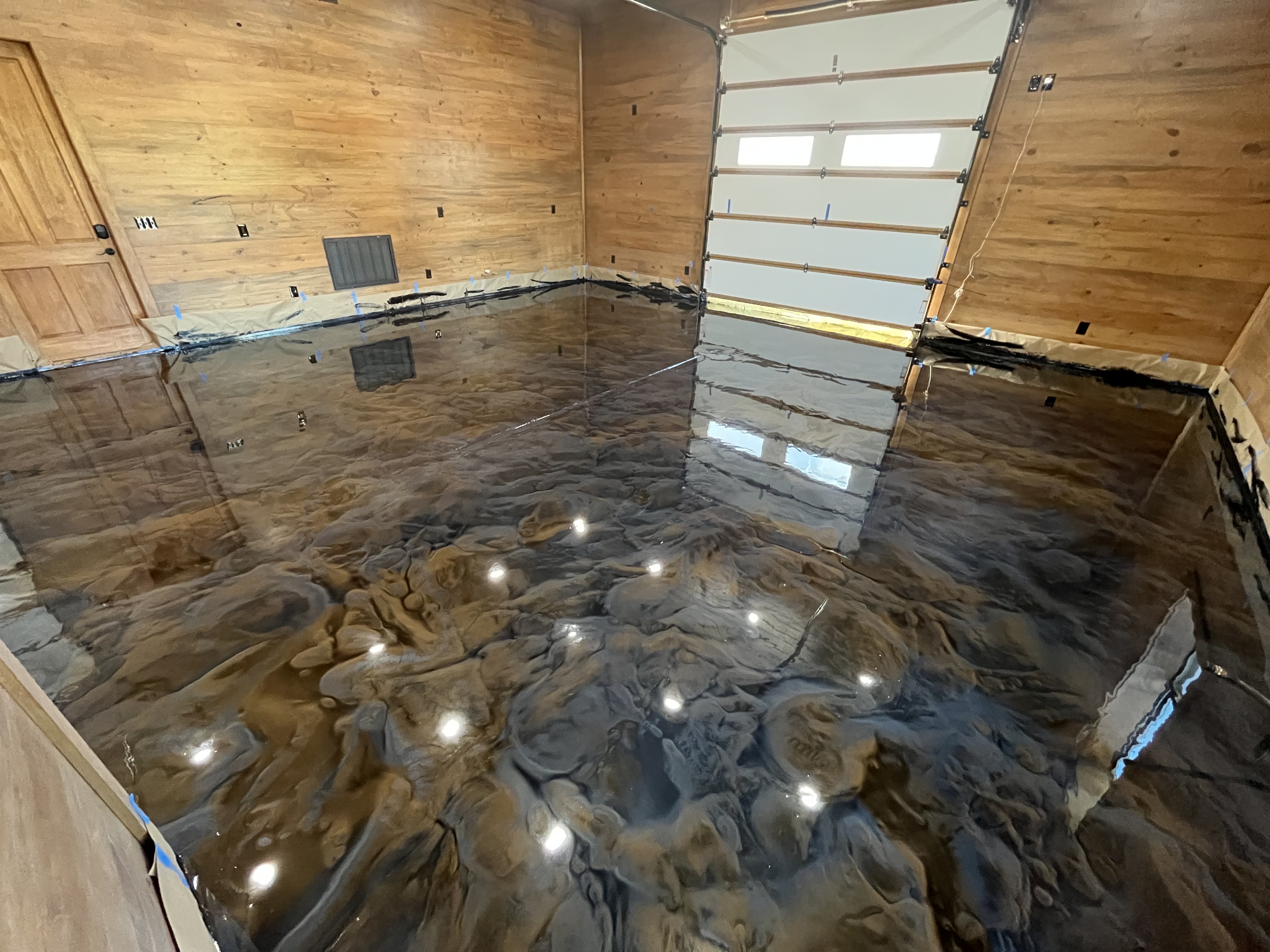 Inside a Garage With a Stylish Black Floor and Rustic Wood Walls 2