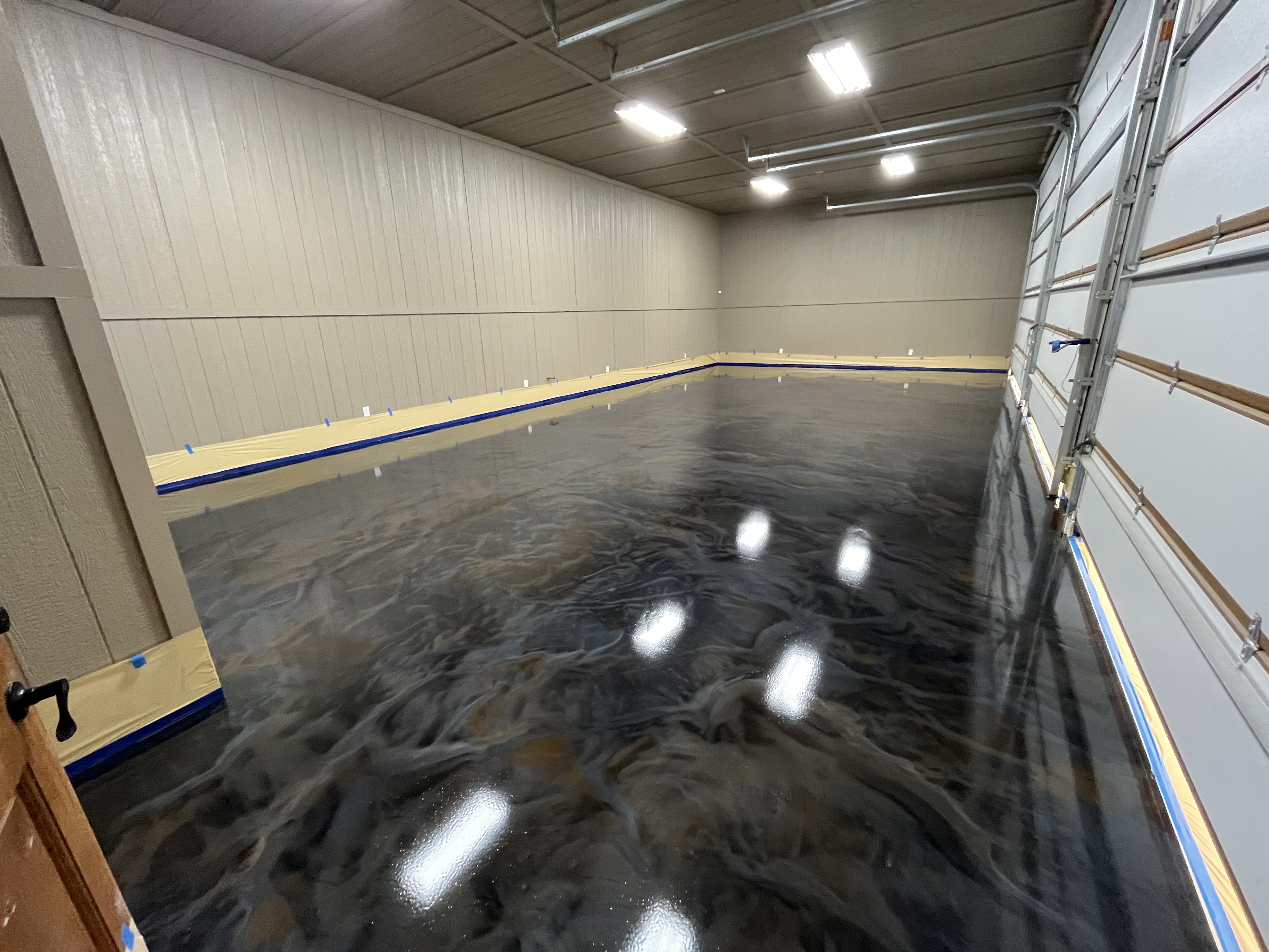 A garage featuring a sleek, shiny black floor